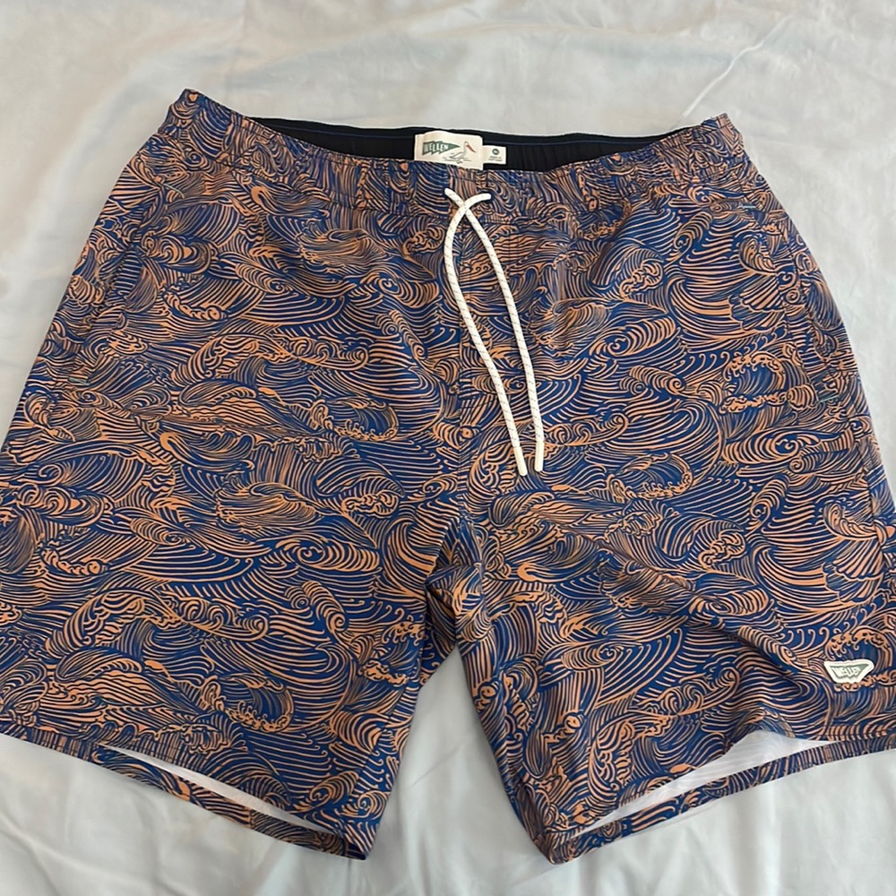 Wellen beach shorts.  Color is dark blue with rust color waves.  9” inseam